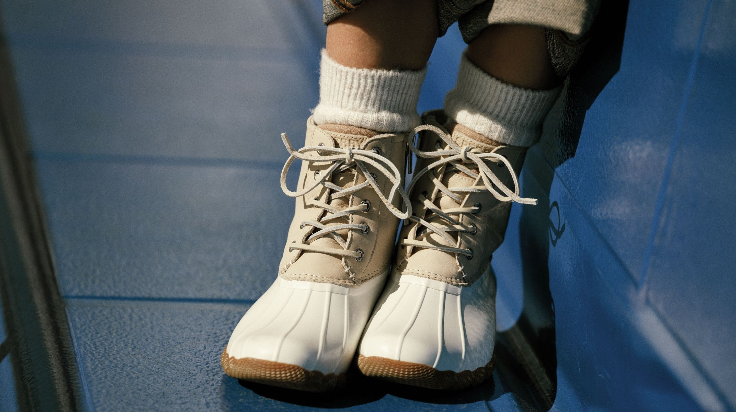 White and beige boots on a blue bench